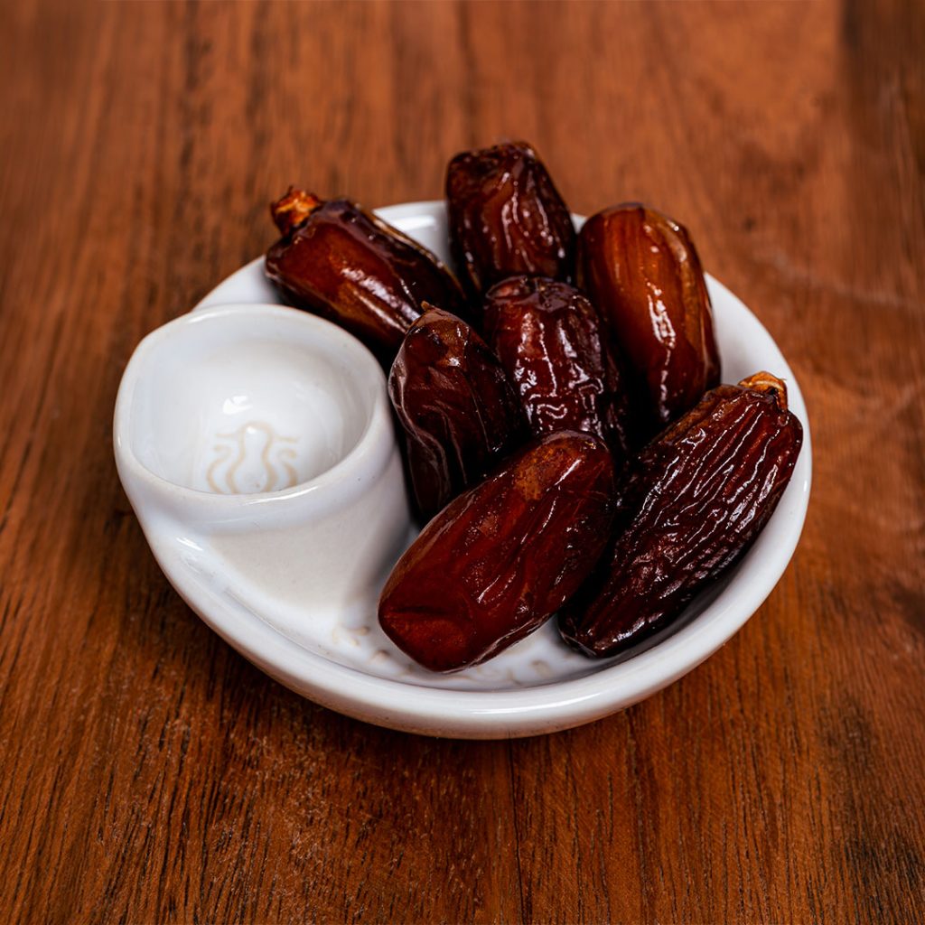 Plate of dates on wooden table